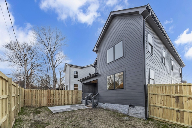 rear view of house featuring crawl space and a fenced backyard