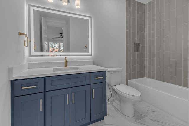 full bathroom featuring a ceiling fan, toilet, marble finish floor, bathtub / shower combination, and vanity