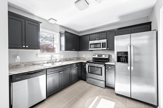 kitchen with light countertops, appliances with stainless steel finishes, and a sink