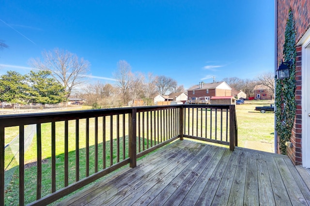 wooden terrace featuring a yard