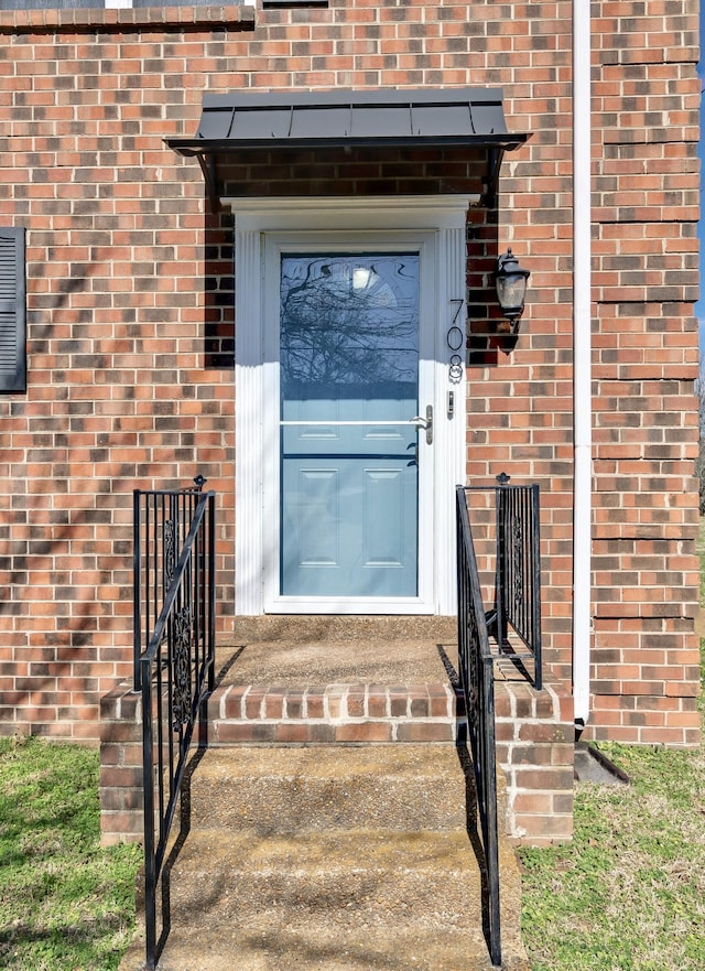 entrance to property with brick siding