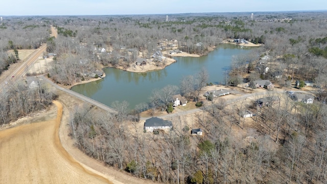 bird's eye view with a water view and a wooded view