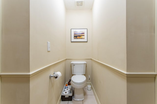 bathroom featuring tile patterned flooring, visible vents, and toilet