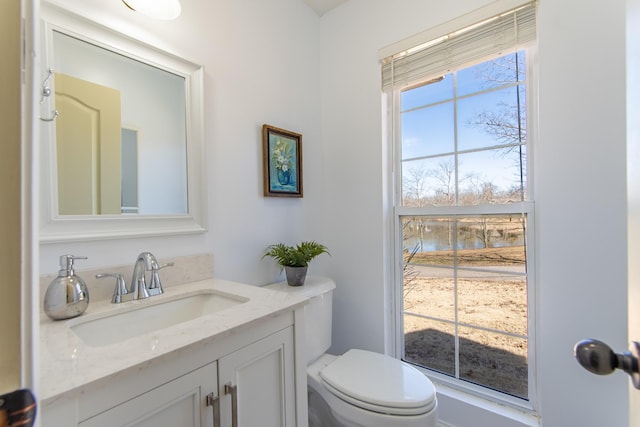 bathroom featuring toilet and vanity