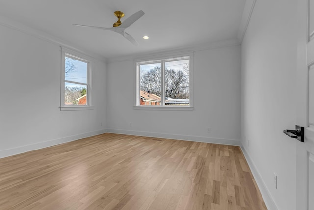 spare room featuring recessed lighting, ornamental molding, light wood-style floors, a ceiling fan, and baseboards