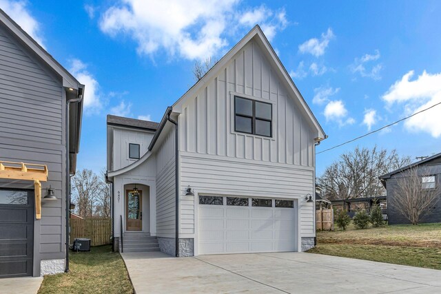 modern farmhouse style home featuring driveway, a garage, central AC unit, fence, and board and batten siding