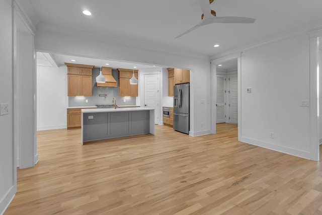 kitchen featuring light wood-style floors, premium range hood, light countertops, and stainless steel fridge with ice dispenser