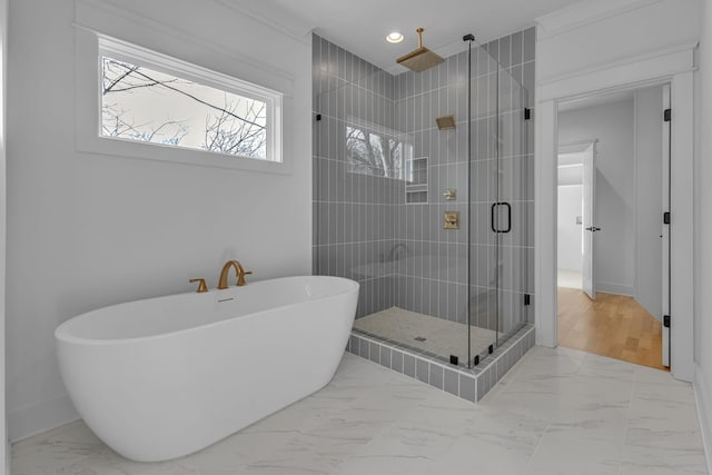 bathroom featuring a freestanding tub, recessed lighting, baseboards, marble finish floor, and a stall shower