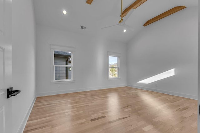 spare room with visible vents, light wood-style floors, ceiling fan, high vaulted ceiling, and baseboards