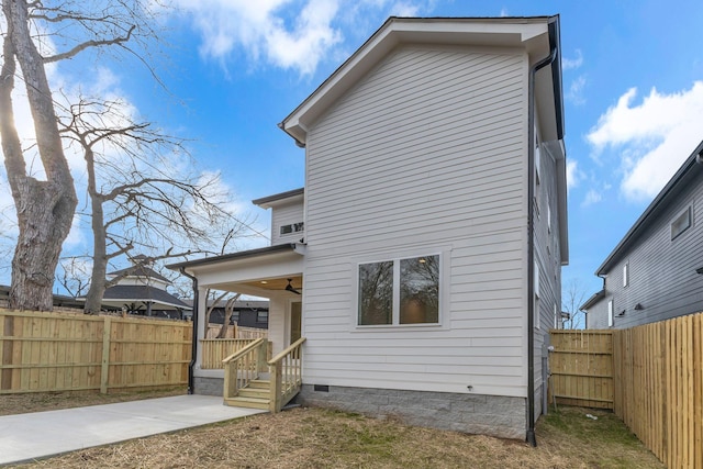 back of house featuring crawl space, a fenced backyard, and a ceiling fan