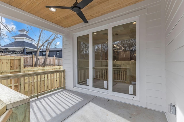 view of patio / terrace with fence and a ceiling fan