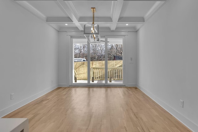 unfurnished dining area with recessed lighting, coffered ceiling, wood finished floors, baseboards, and beamed ceiling