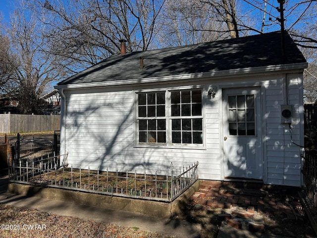 view of outbuilding with fence and an outdoor structure