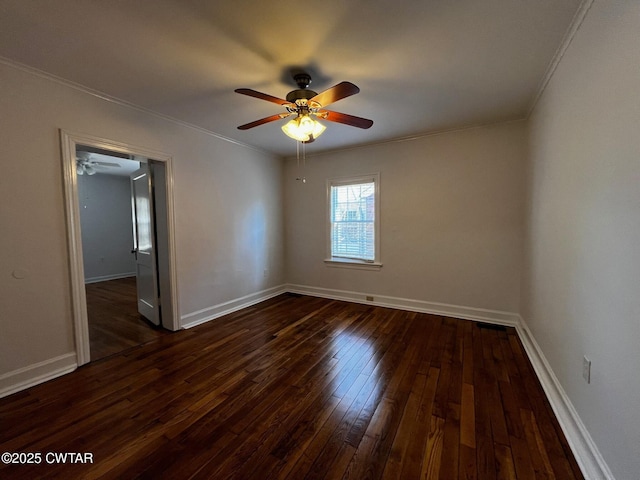 spare room featuring baseboards, ornamental molding, dark wood finished floors, and a ceiling fan