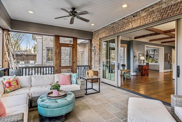 sunroom featuring french doors and ceiling fan