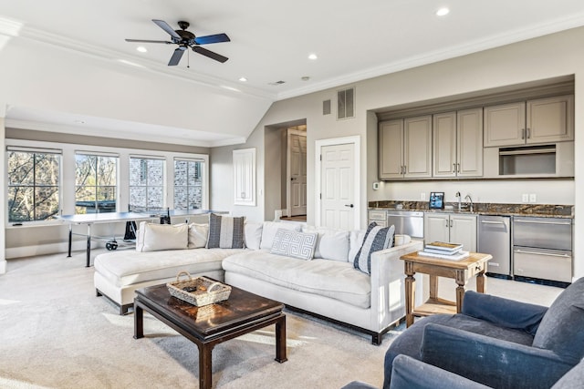 living area featuring light carpet, visible vents, crown molding, and recessed lighting