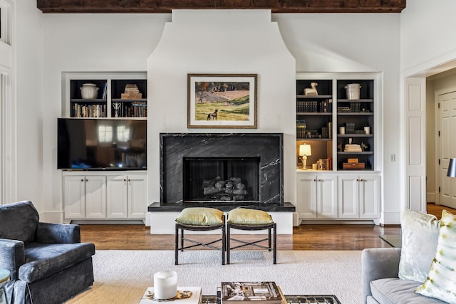 living room with wood finished floors and a high end fireplace