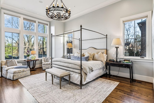 bedroom featuring a chandelier, ornamental molding, dark wood-style floors, and baseboards