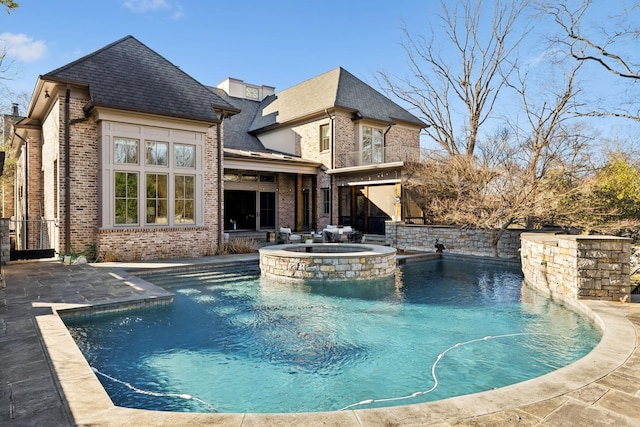 view of swimming pool with a pool with connected hot tub and a patio