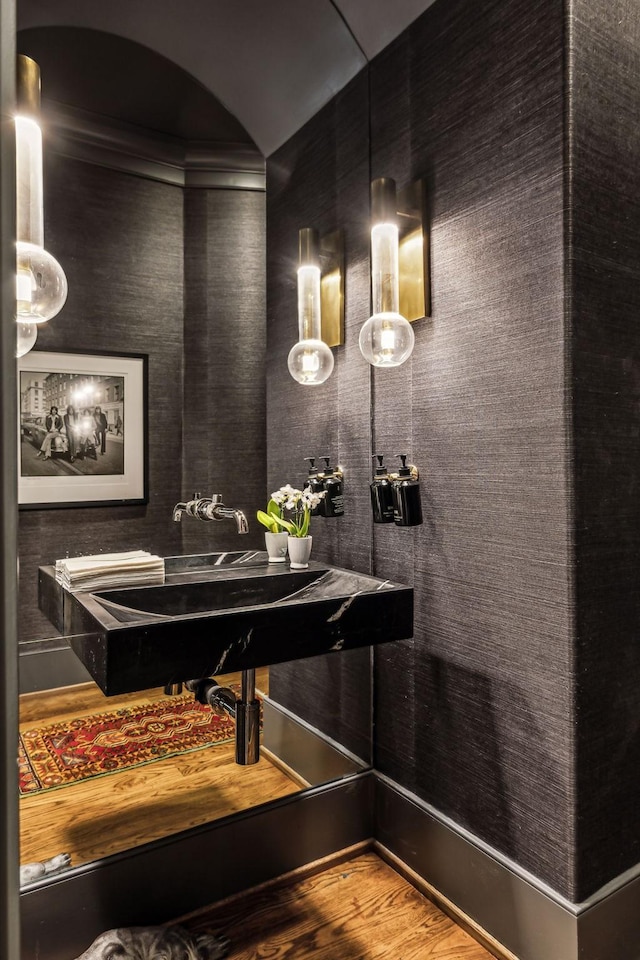 bathroom with a sink and wood finished floors