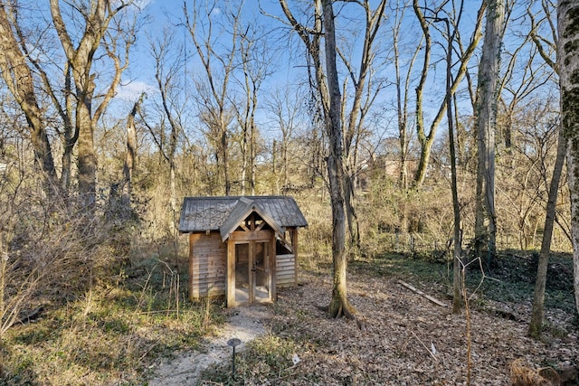 view of shed featuring a view of trees