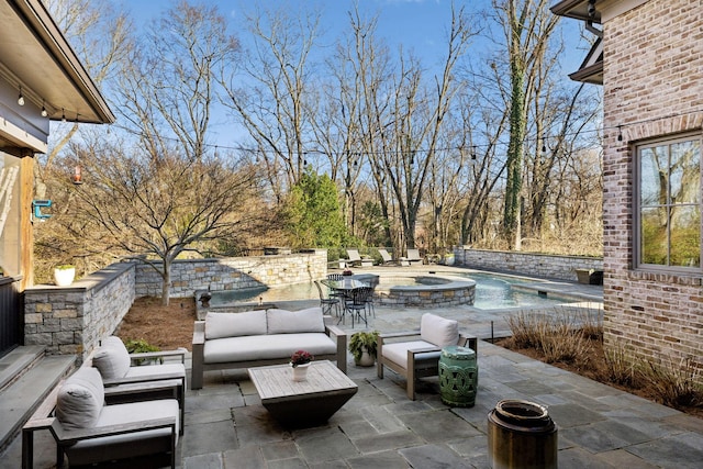 view of patio featuring an outdoor hangout area and a pool with connected hot tub