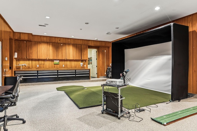 game room with golf simulator, wood walls, visible vents, and recessed lighting