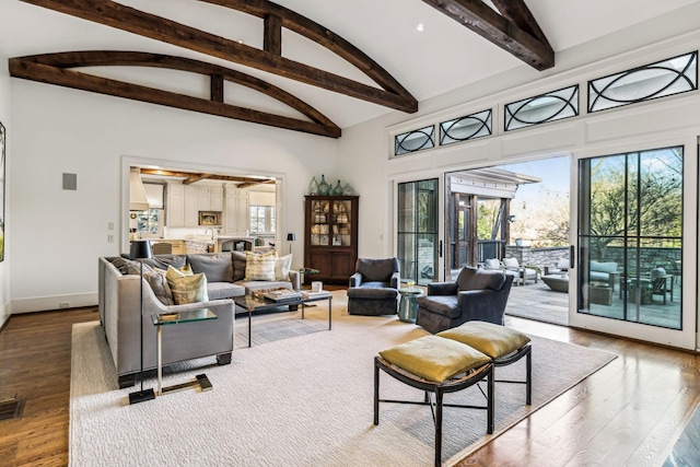 living area with baseboards, wood finished floors, beamed ceiling, high vaulted ceiling, and recessed lighting