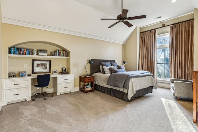 bedroom with light carpet, visible vents, lofted ceiling, crown molding, and built in desk