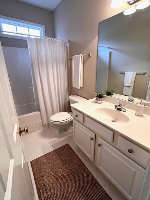 bathroom with tile patterned flooring, toilet, vanity, and shower / bathtub combination with curtain