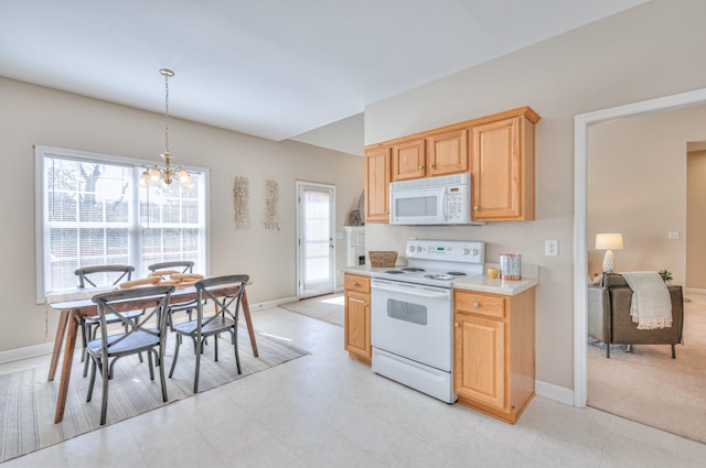 kitchen featuring white appliances, baseboards, light brown cabinetry, light countertops, and a notable chandelier