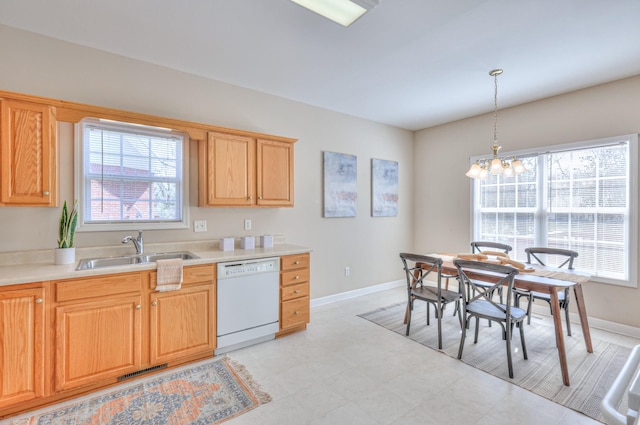 kitchen with visible vents, a sink, an inviting chandelier, white dishwasher, and light countertops