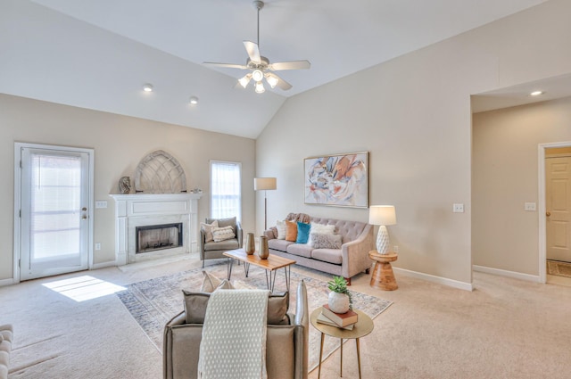 carpeted living room with baseboards, lofted ceiling, recessed lighting, a high end fireplace, and ceiling fan