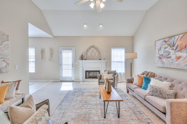 living area with a high end fireplace, high vaulted ceiling, light carpet, and baseboards