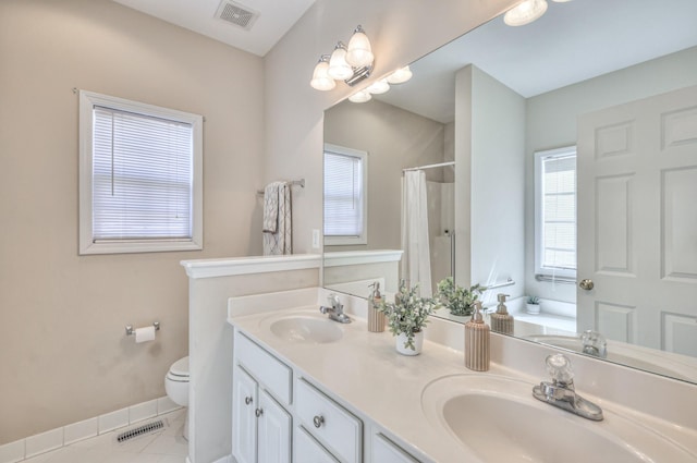 bathroom featuring visible vents, toilet, and a sink