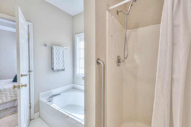 ensuite bathroom with connected bathroom, a garden tub, and a stall shower