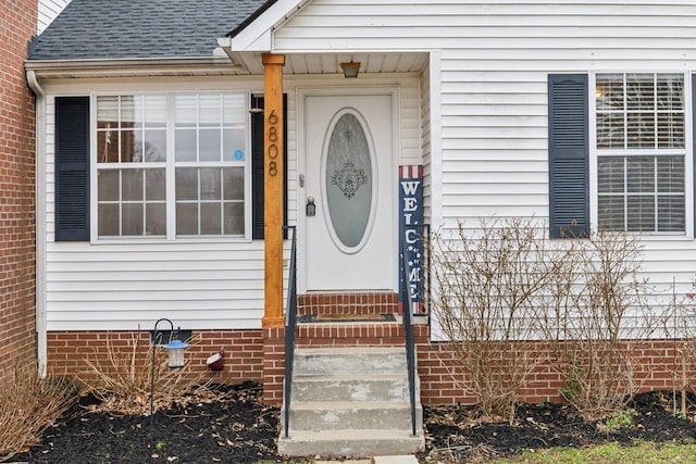 property entrance featuring crawl space and roof with shingles