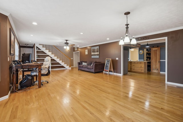 living room with light wood-style floors, stairway, and crown molding