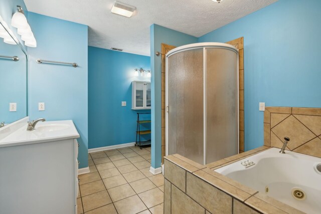 full bath with a stall shower, visible vents, a whirlpool tub, tile patterned flooring, and a textured ceiling