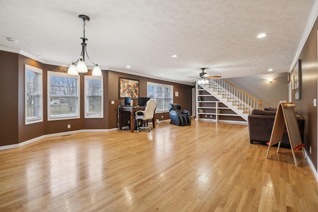 interior space with baseboards, light wood-style flooring, stairs, crown molding, and a textured ceiling