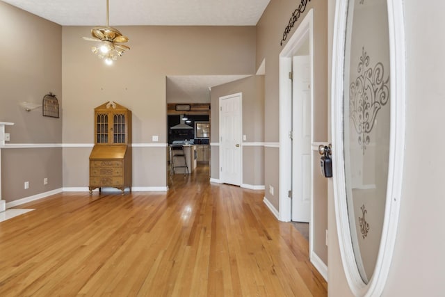 entrance foyer with light wood-style floors and baseboards