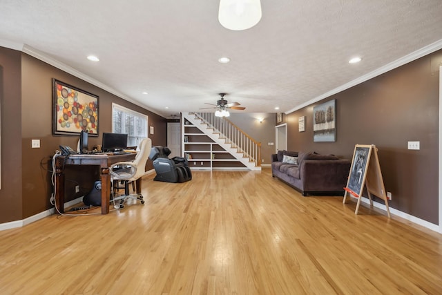 living area with light wood-style flooring, stairs, baseboards, and crown molding