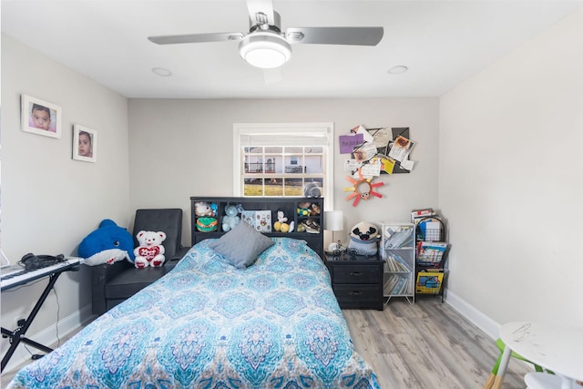 bedroom with ceiling fan, baseboards, and wood finished floors