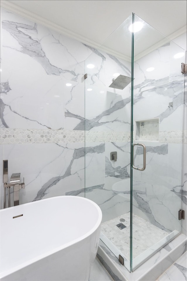 bathroom with a freestanding bath, marble finish floor, and a marble finish shower