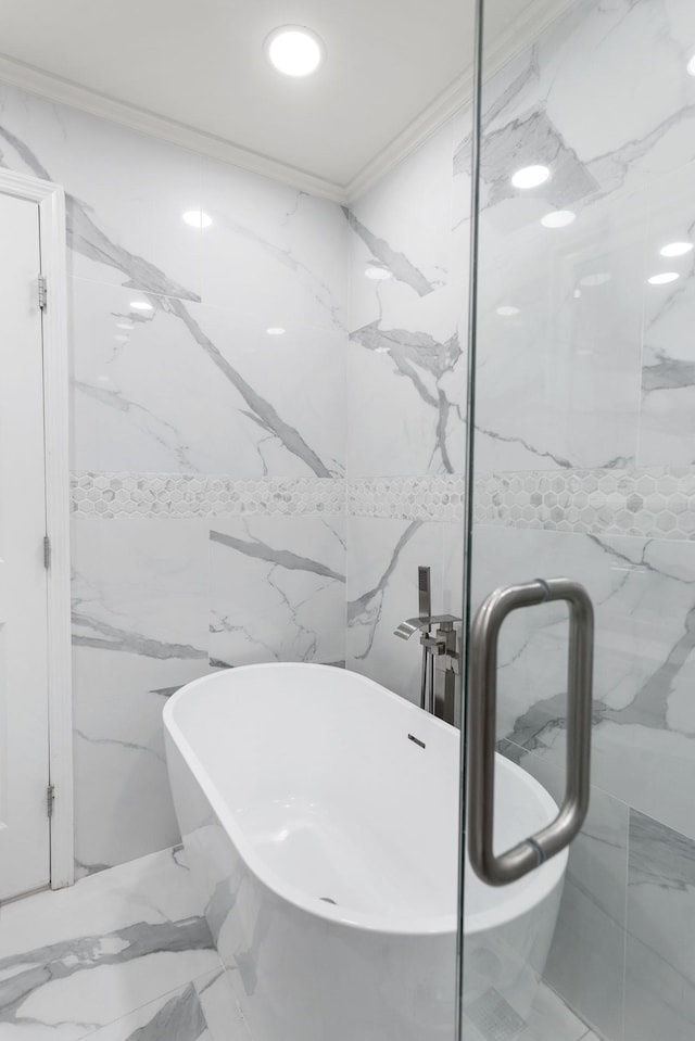 bathroom with stone wall, ornamental molding, and a soaking tub