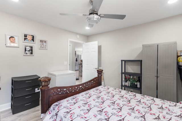 bedroom featuring ceiling fan, baseboards, and wood finished floors