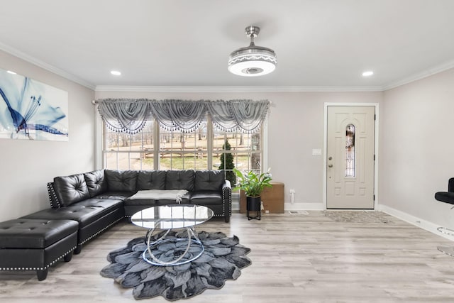 living area featuring ornamental molding, recessed lighting, baseboards, and wood finished floors