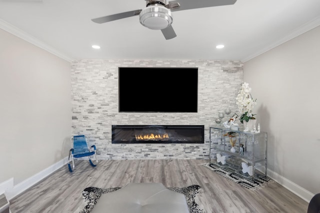 unfurnished living room featuring baseboards, a stone fireplace, and crown molding