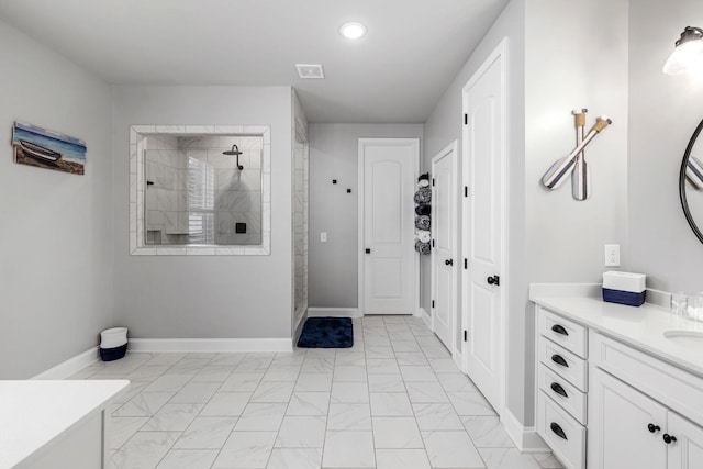 bathroom with marble finish floor, vanity, baseboards, and walk in shower