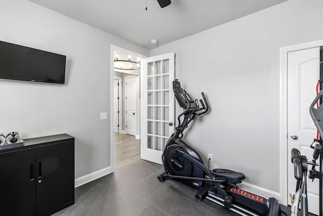 exercise area with ceiling fan and baseboards